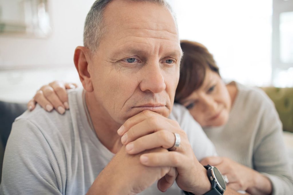 Married husband struggling with addiction and wife is comforting him